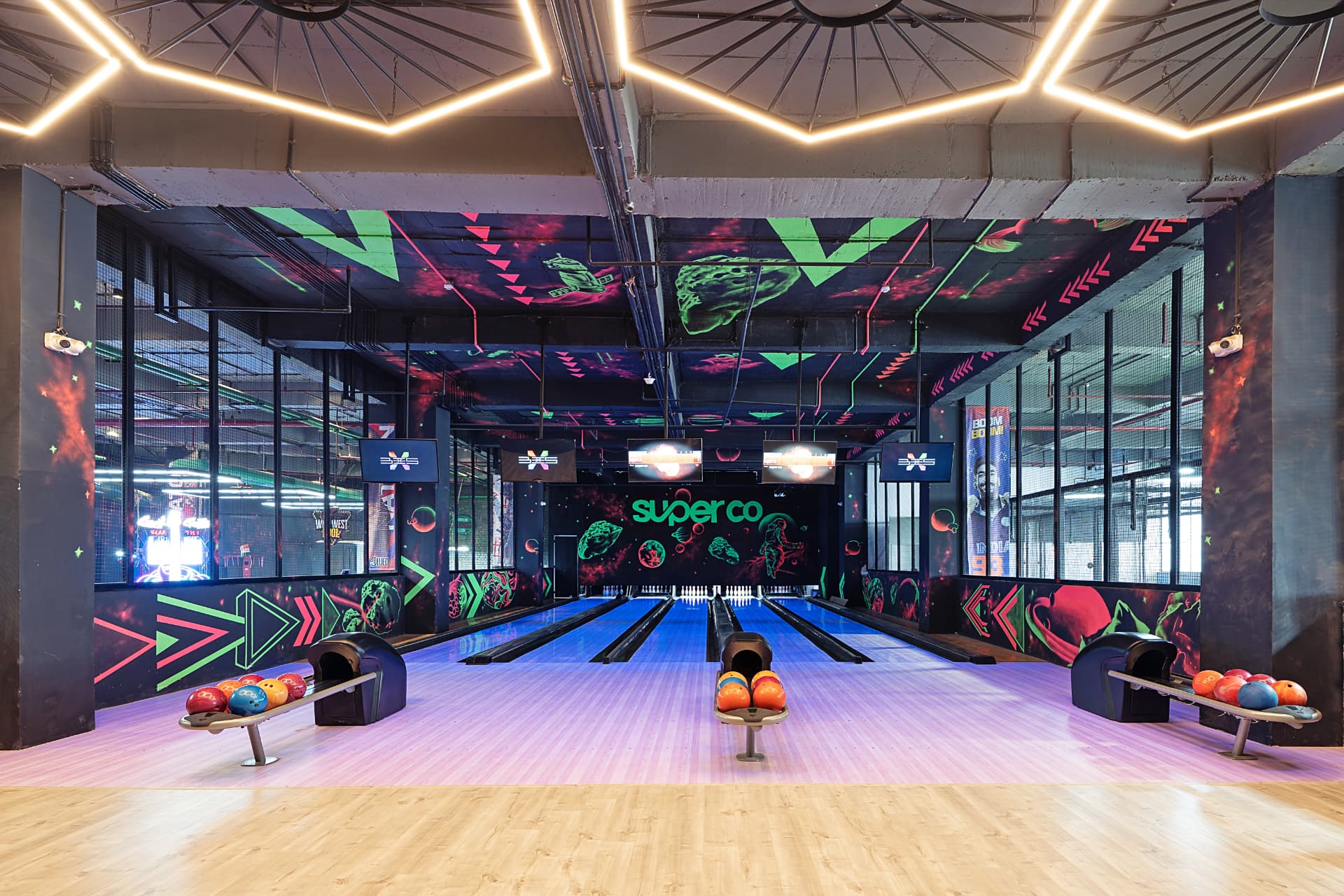 Neon-muralled bowling alley with glowing lanes