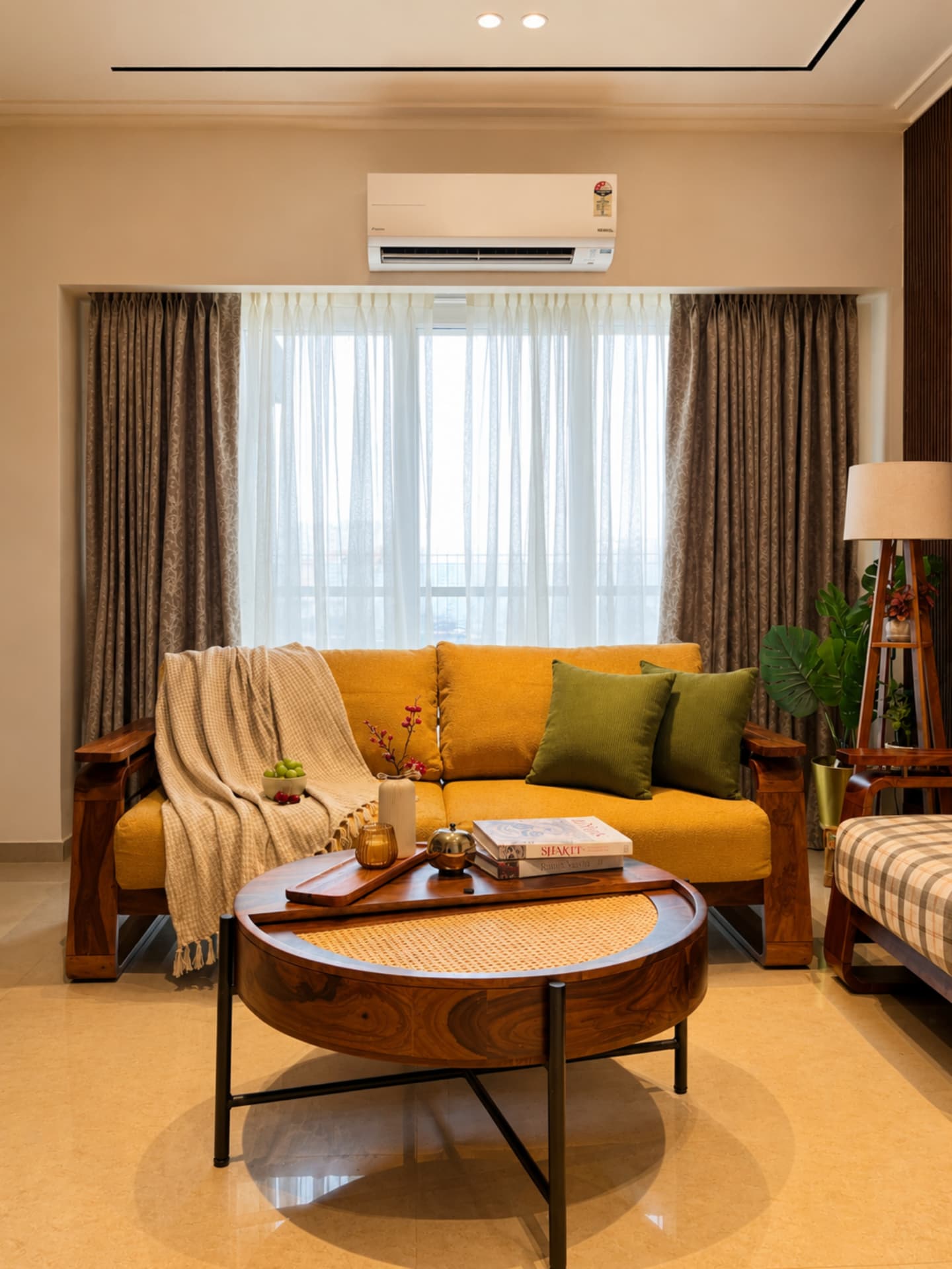 Living room with mustard teak sofa, cane coffee table and sheer-filtered daylight